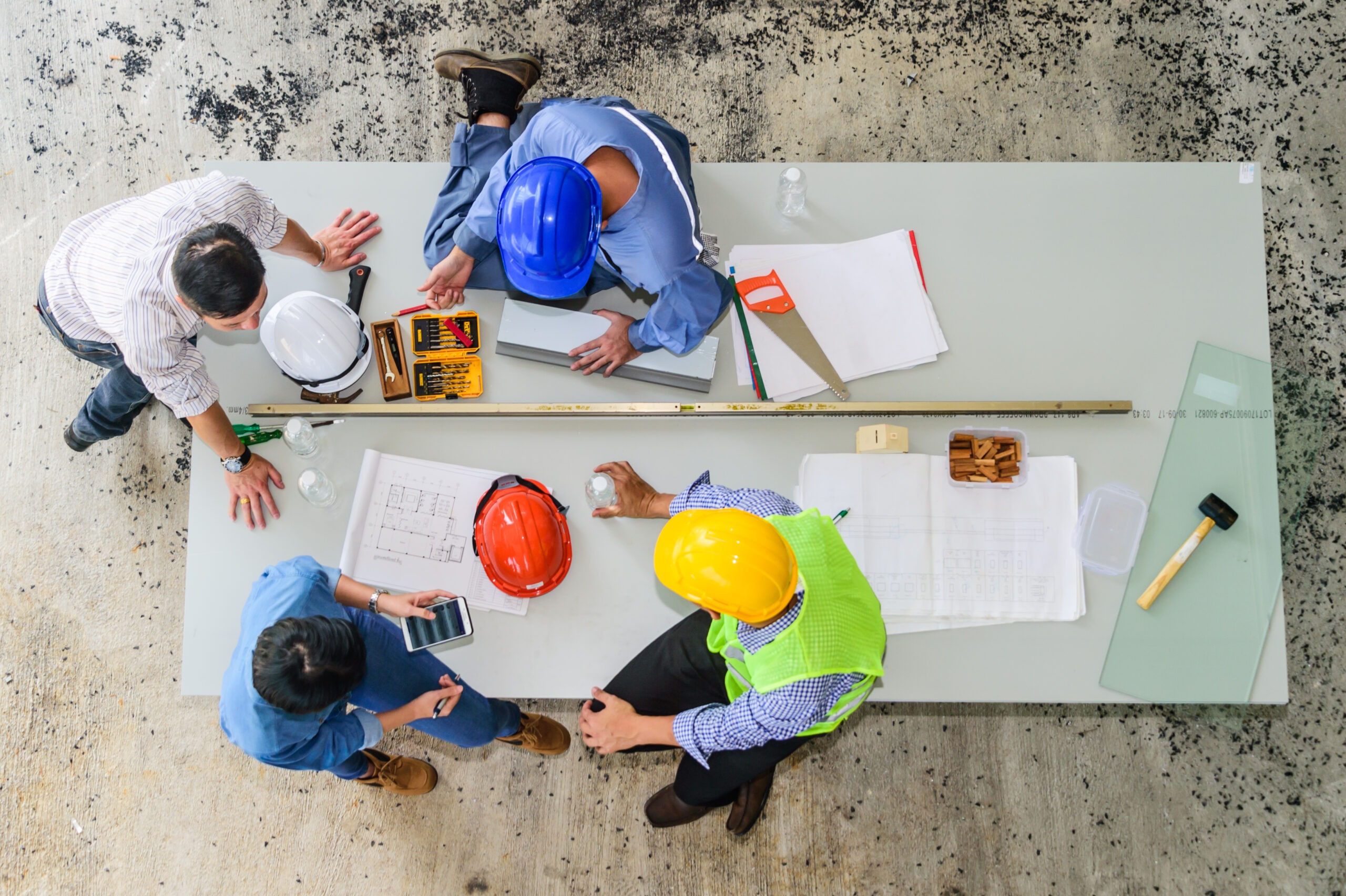 Field Engineer and Foreman Looking at Constructed Paper Blueprint Plans